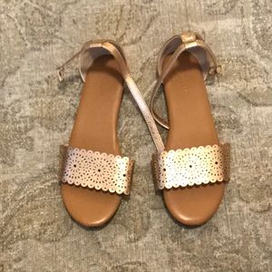 Gold metallic sandals.